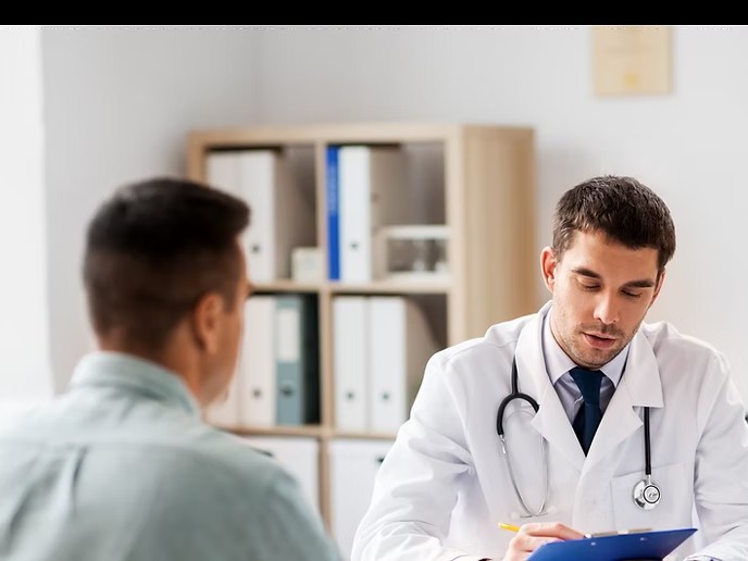 A physician in consultation with an adult patient